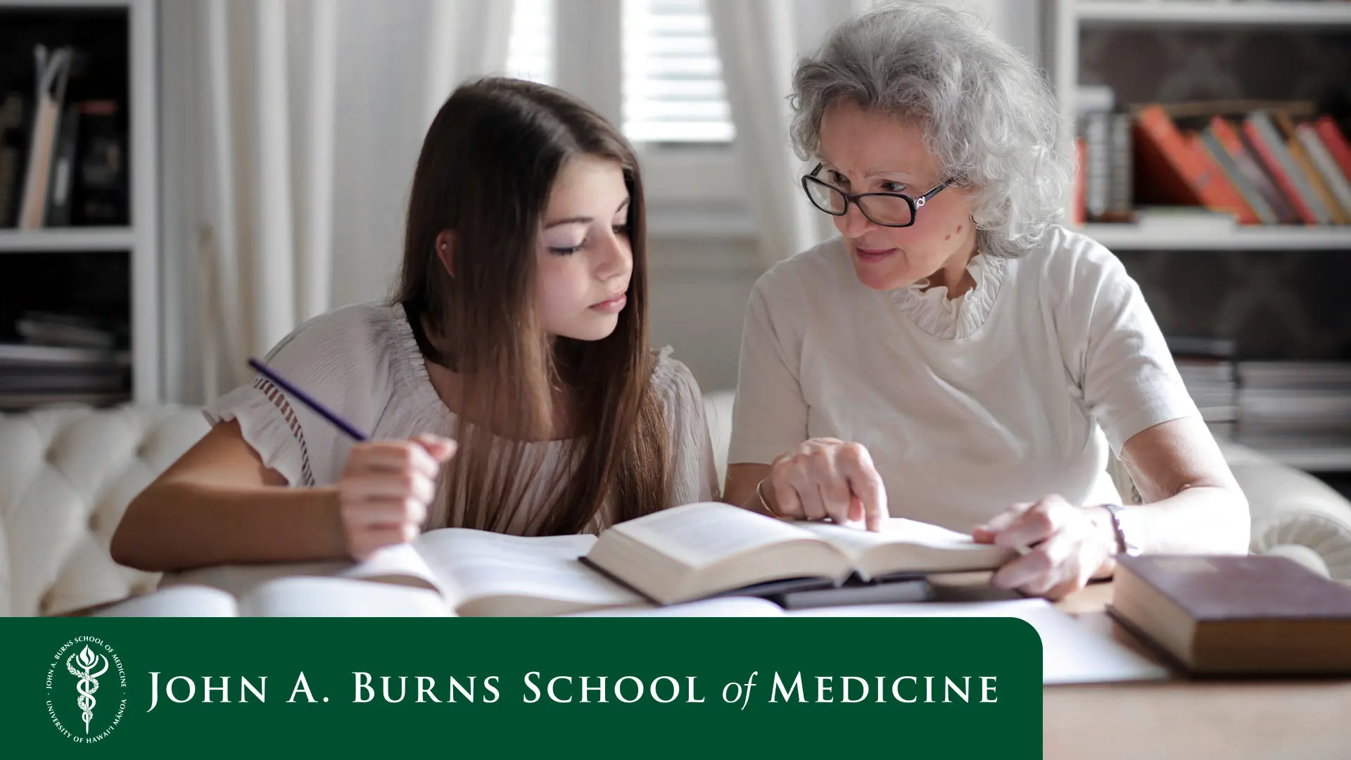 grandmother helping grand daughter with homework