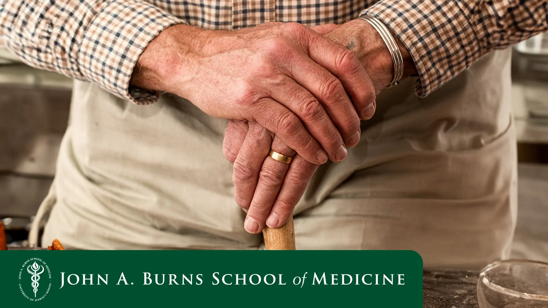 man's hand clutching his cane